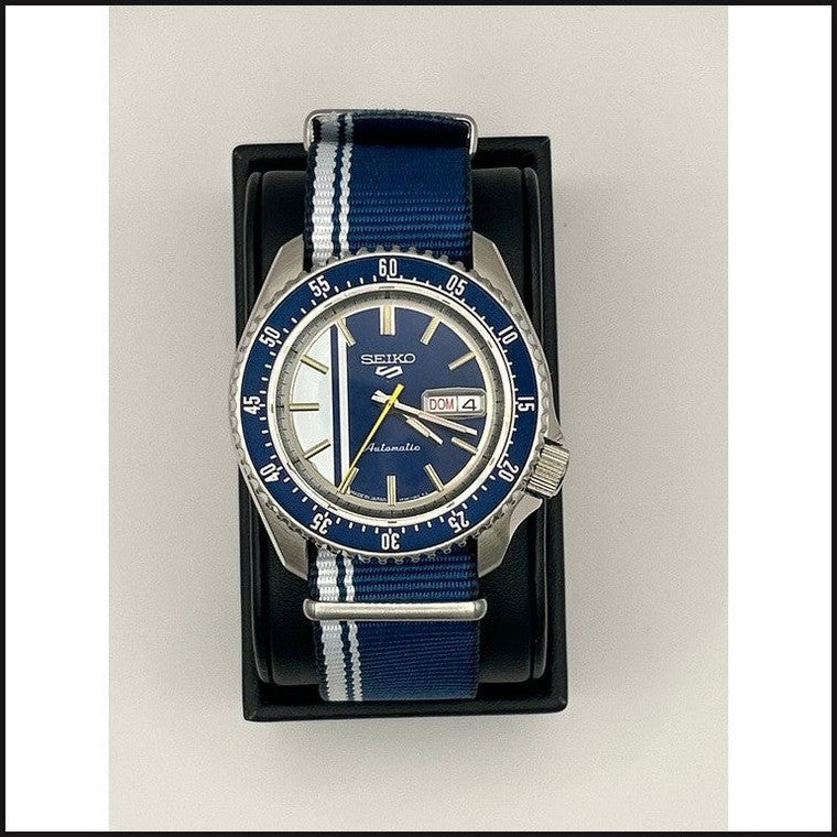 Gents Automatic blue & silver dial yellow markers 5 sports watch w/ blue & white strap