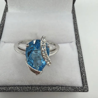 Sterling silver blue topaz ring with white topaz ribbon