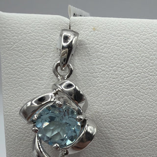 Sterling silver blue topaz pendant with twisted ribbon frame