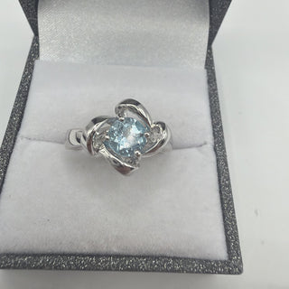Sterling silver blue topaz ring with twisted ribbon frame