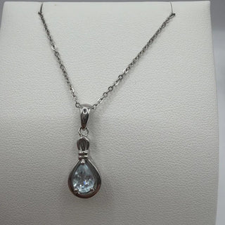 Sterling silver blue topaz pear pendant in open teardrop frame