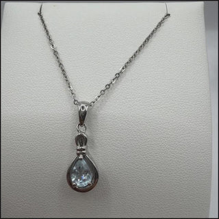 Sterling silver blue topaz pear pendant in open teardrop frame