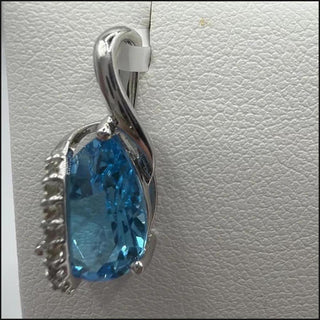 Sterling silver blue topaz pendant with white topaz accents