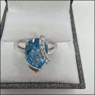 Sterling silver blue topaz ring with white topaz ribbon