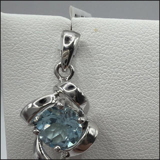 Sterling silver blue topaz pendant with twisted ribbon frame