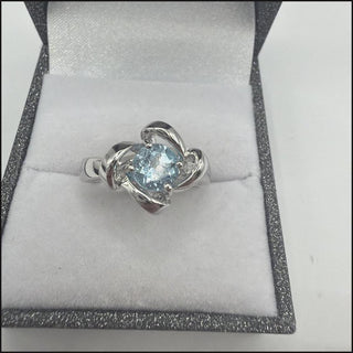 Sterling silver blue topaz ring with twisted ribbon frame