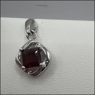 Sterling silver garnet pendant, square-cut garnet in twisted open frame