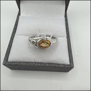 Sterling silver oval golden citrine ring with green accent stone