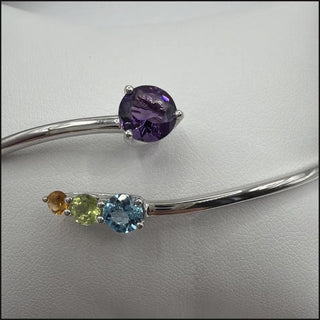 Sterling silver bypass bangle with amethyst, blue topaz, peridot and citrine